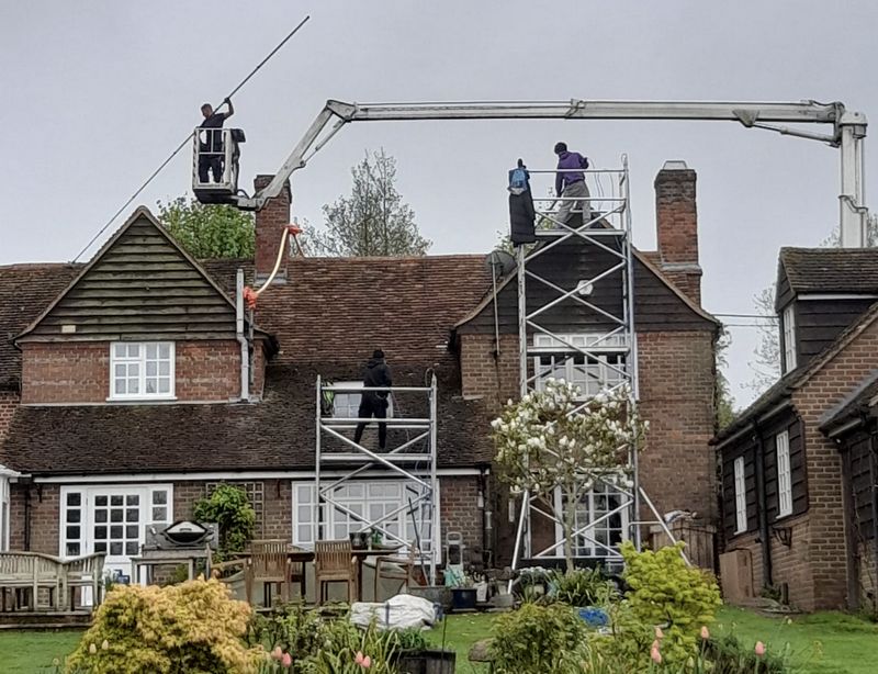 The Moss Cleaners using cherry picker and scaffolding to clean roof safely and professionally in Gosport, Hampshire